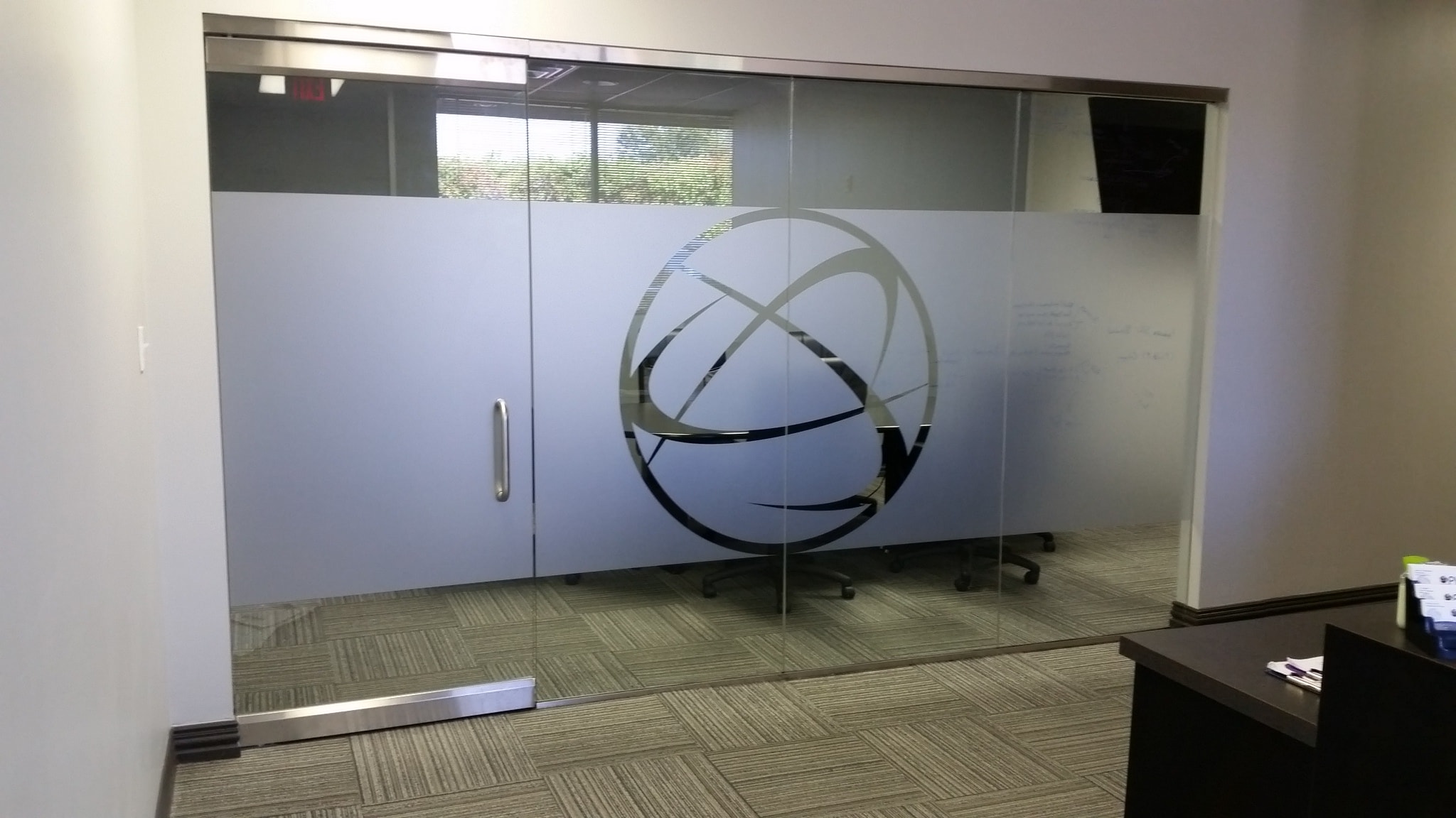PHD conference room frosted glass sliding door with company logo graphic by Architectural Wraps