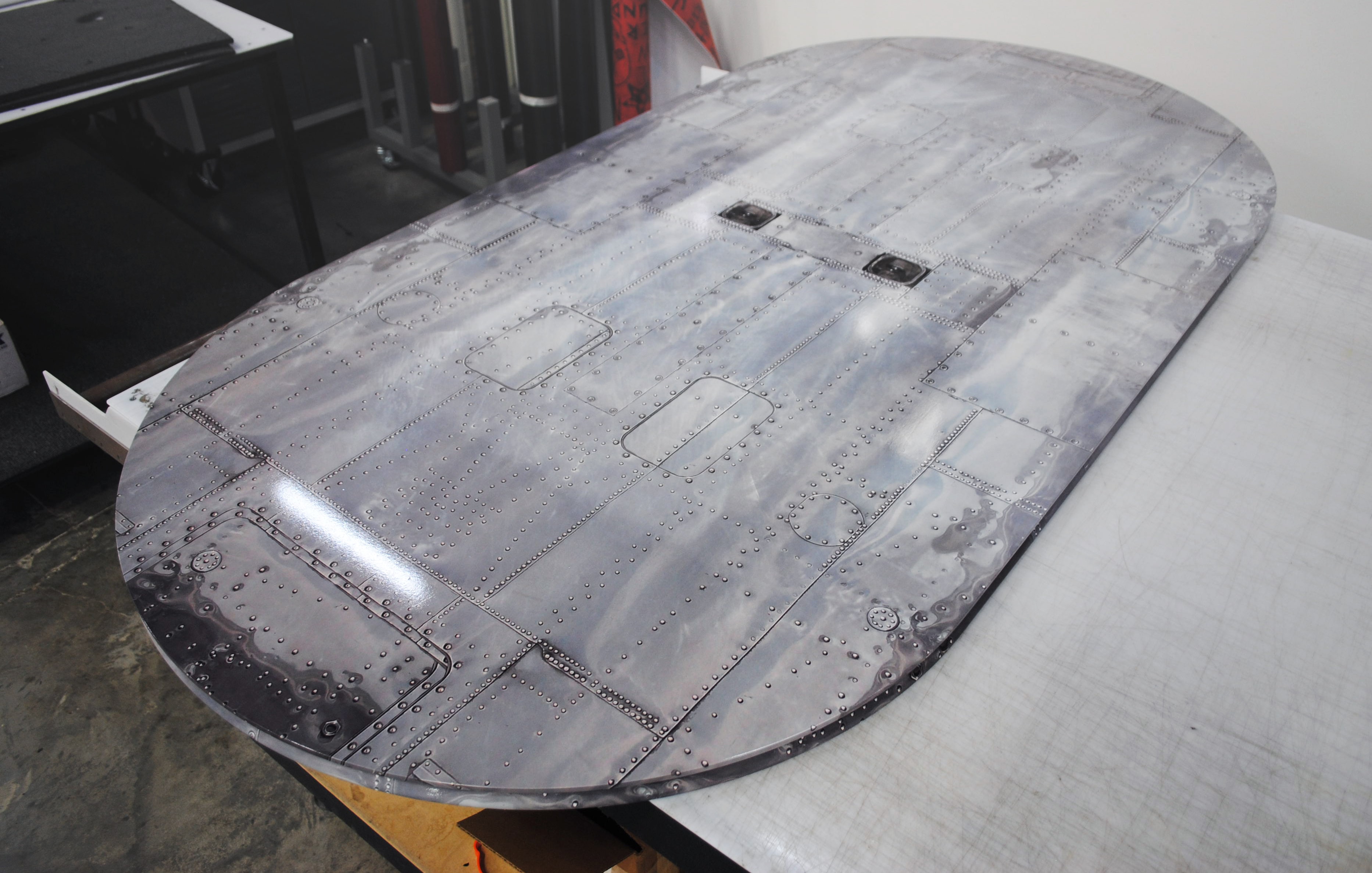 Conference table surface wrap with aircraft aluminum riveted panel graphic by Architectural Wraps