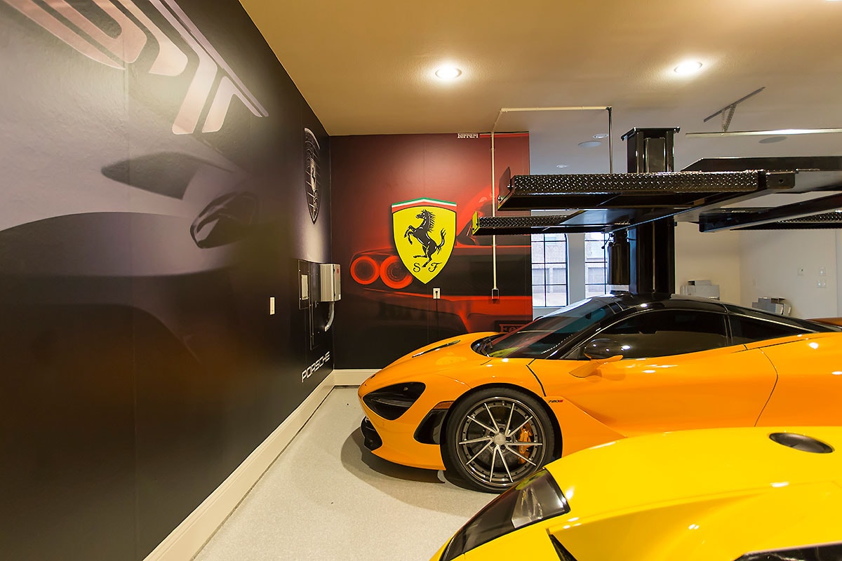Private luxury garage wall murals featuring Ferrari and Porsche supercar graphics by Architectural Wraps