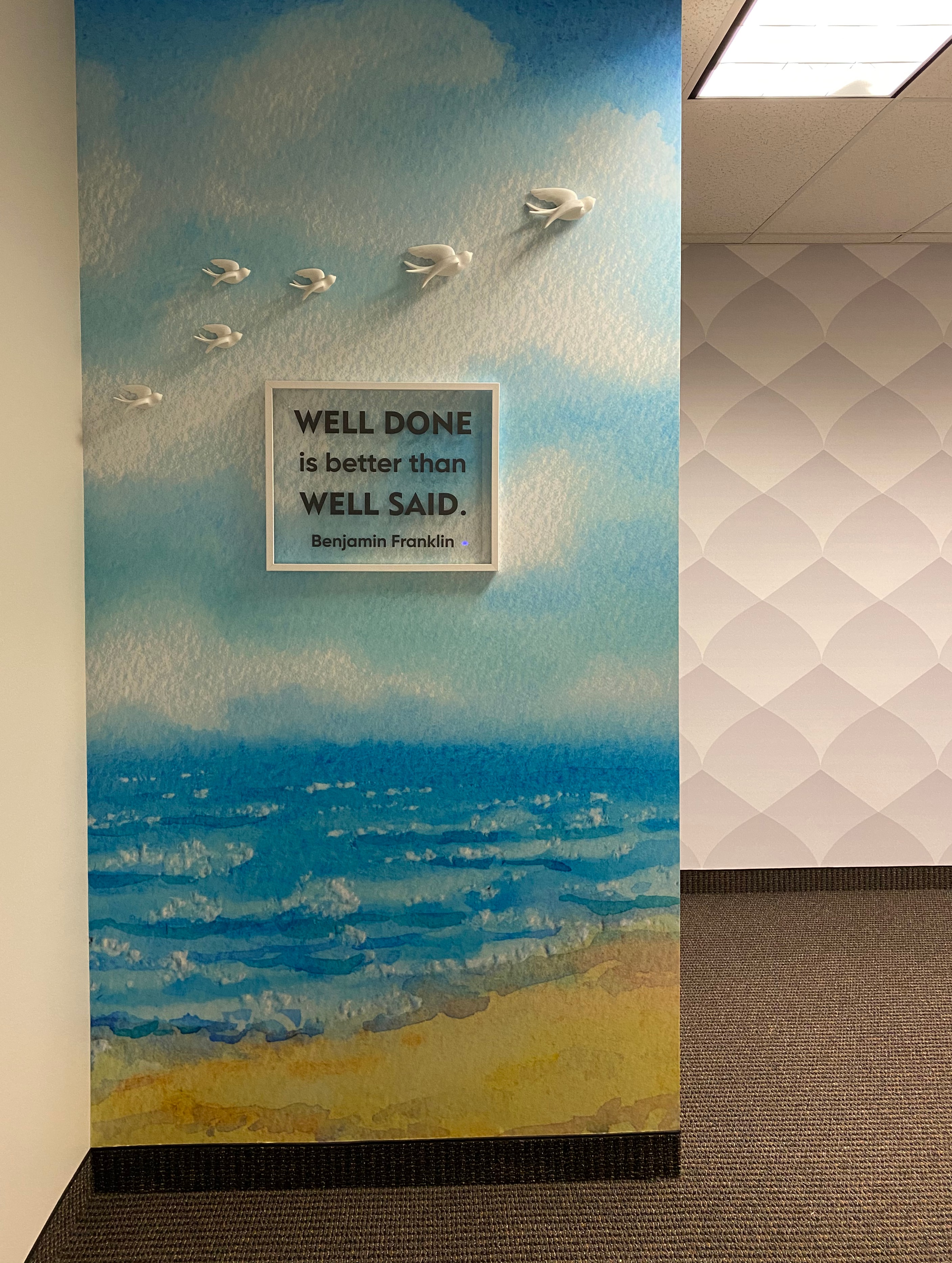 Office hallway watercolor ocean wall mural with Benjamin Franklin quote and 3D bird sculptures by Architectural Wraps