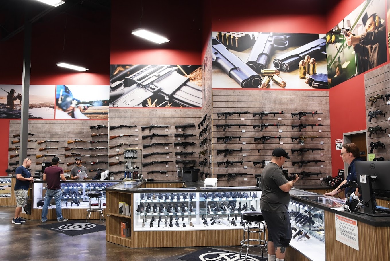 Full firearms retail store branded environment with large-format wall murals and display graphics by Architectural Wraps