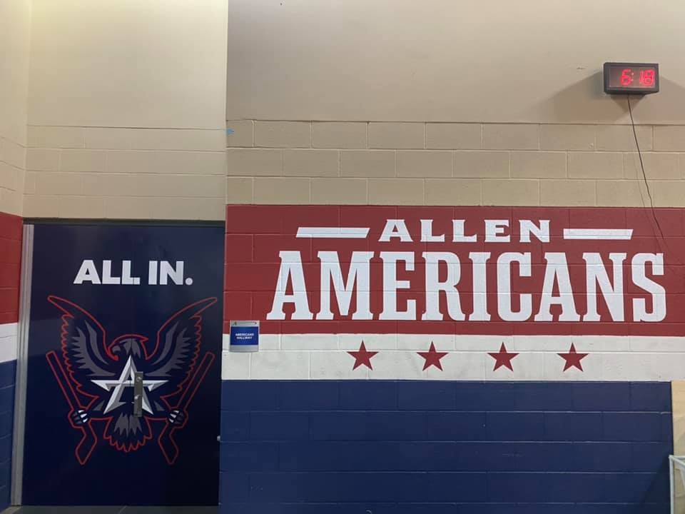 Allen Americans hockey arena hallway with All In door wrap and large Americans wall mural in team colors by Architectural Wraps