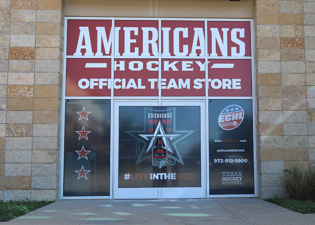 Allen Americans Hockey Official Team Store storefront window graphics with ECHL branding and Live in the Red messaging by Architectural Wraps